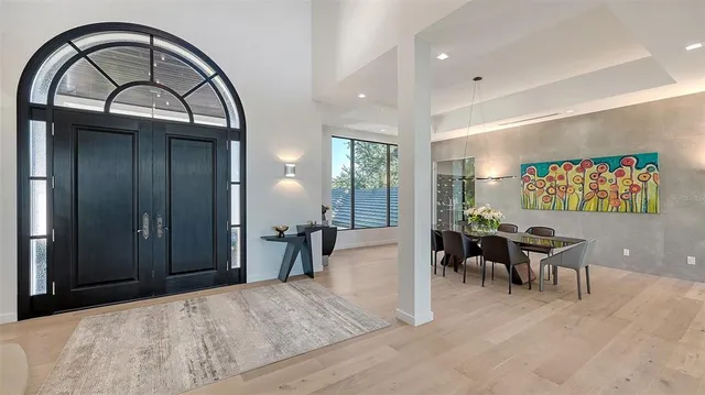 a view of a dining room with furniture large window and wooden floor