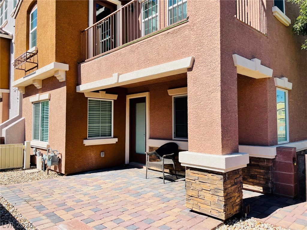 9921 Sable Point Street Las Vegas, NV 89178 - Photo 37 of 43 A spacious paved patio area provides room for outdoor relaxation beneath stucco and stone architecture.