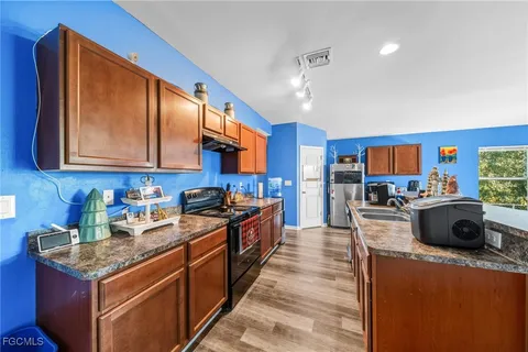 a kitchen with stainless steel appliances granite countertop a stove sink and cabinets