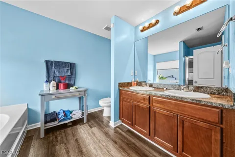 a spacious bathroom with a double vanity sink and a mirror