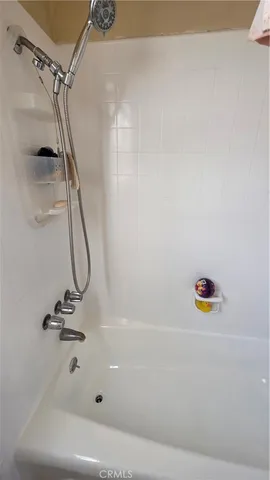 a bathroom with a shower and a bath tub