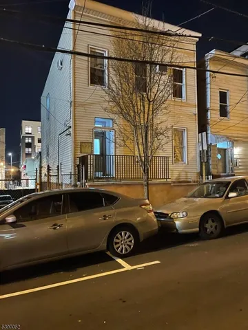 a view of a street that has couple of cars parked on the road