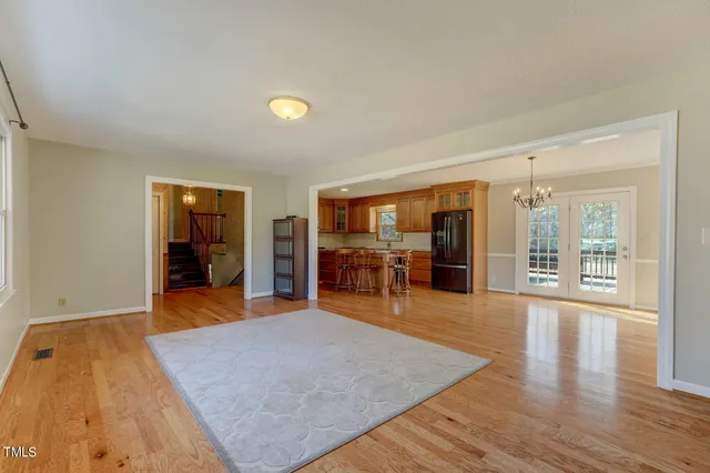 an empty room with wooden floor and furniture