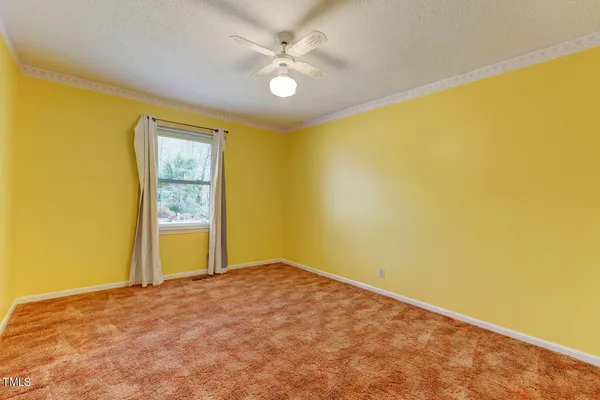 a view of a big room with closet and a ceiling fan