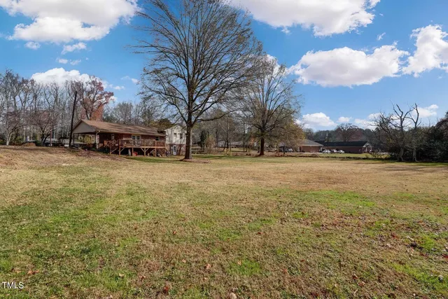 a view of a house with backyard space and a patio