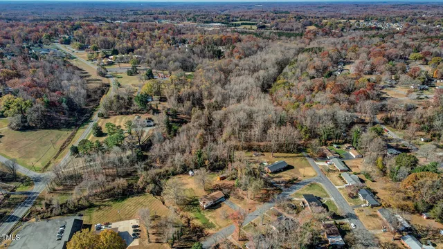 a front view of a house with yard and trees