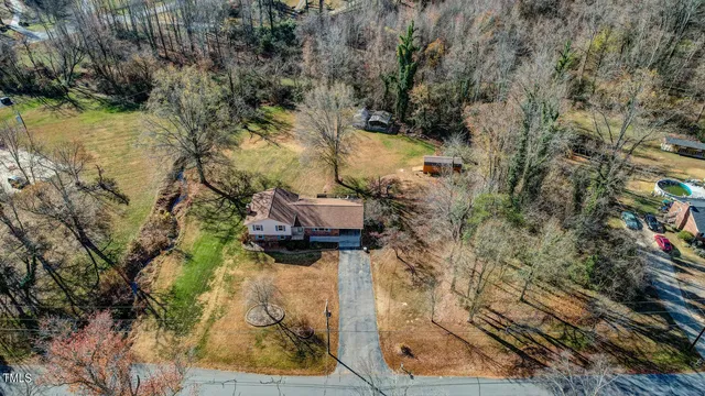 a backyard of a house with a yard and outdoor seating