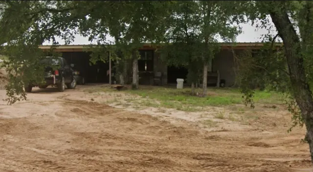 a backyard of a house with lots of green space and fountain