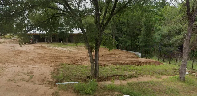 a backyard of a house with lots of green space