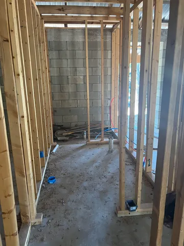 a view of a room with wooden walls and a window