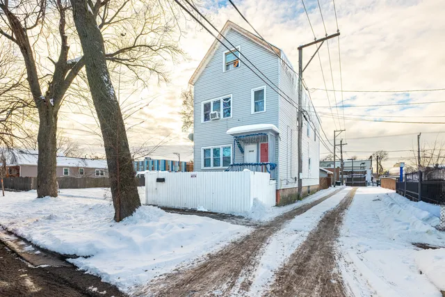 a view of a house with snow on the road
