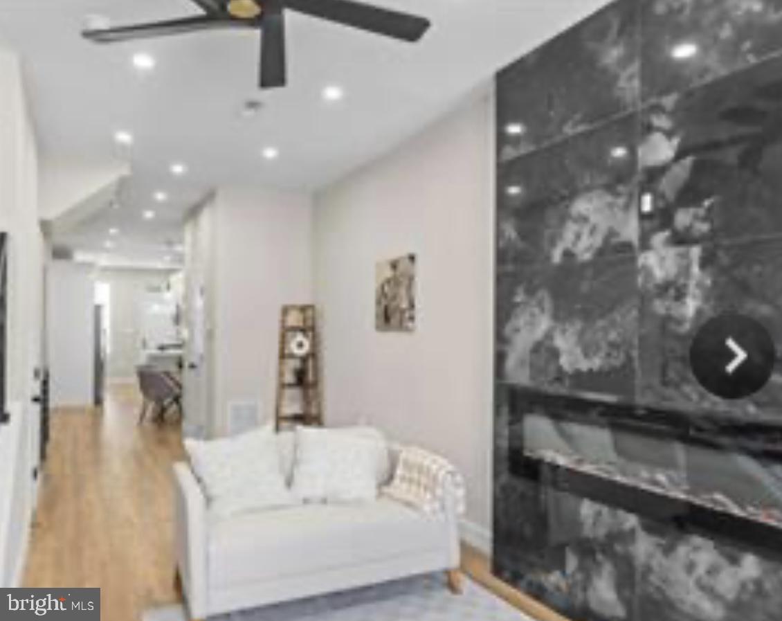 2022 North Fulton Avenue Baltimore, MD 21217 - Photo 2 of 11 a living room with furniture and a wooden floor