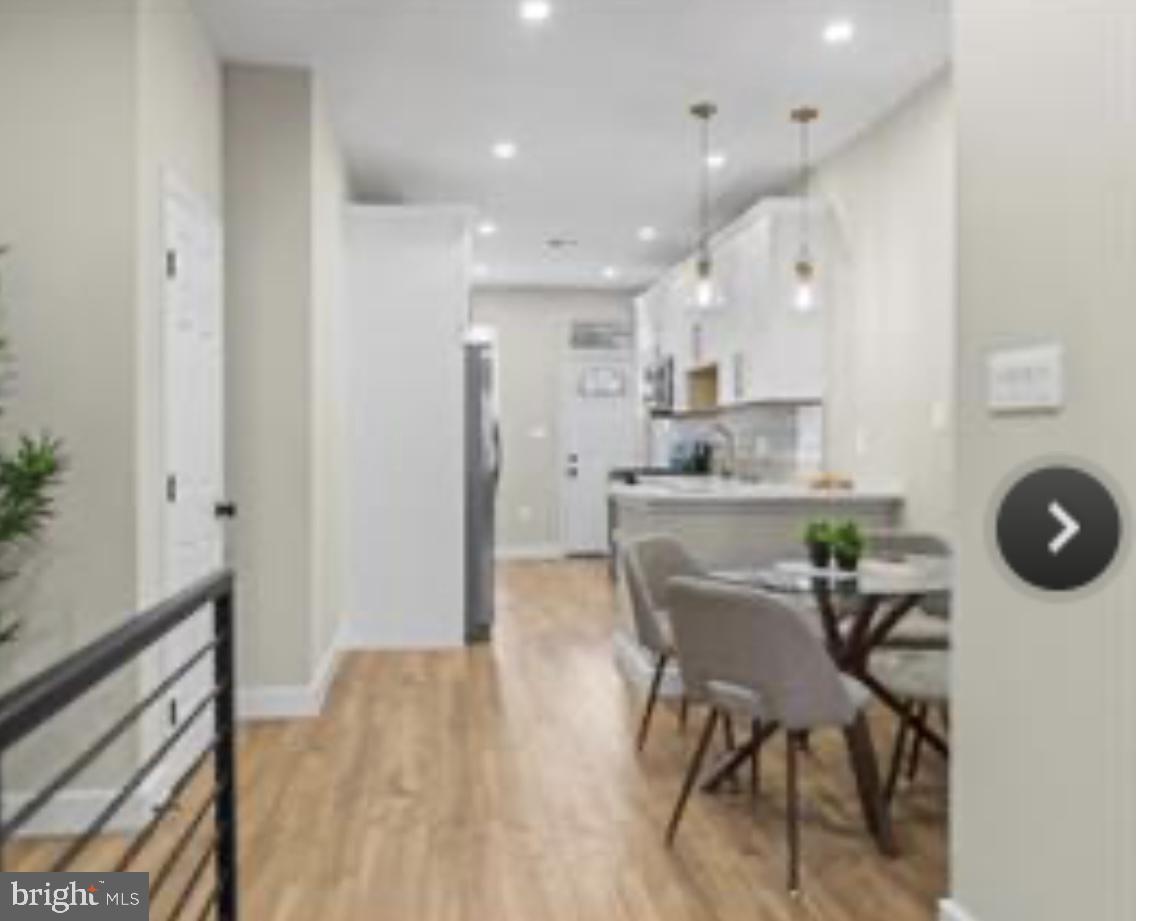 2022 North Fulton Avenue Baltimore, MD 21217 - Photo 5 of 11 a view of a dining room with furniture and wooden floor