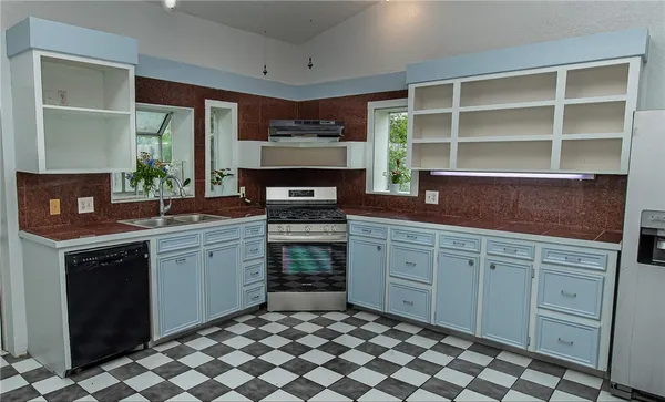 a kitchen with a cabinets and window