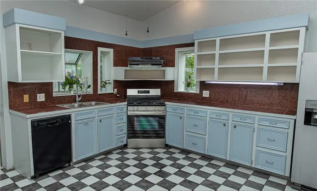 a kitchen with a cabinets and window