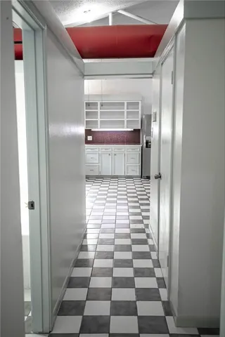 a view of a hallway with seating space
