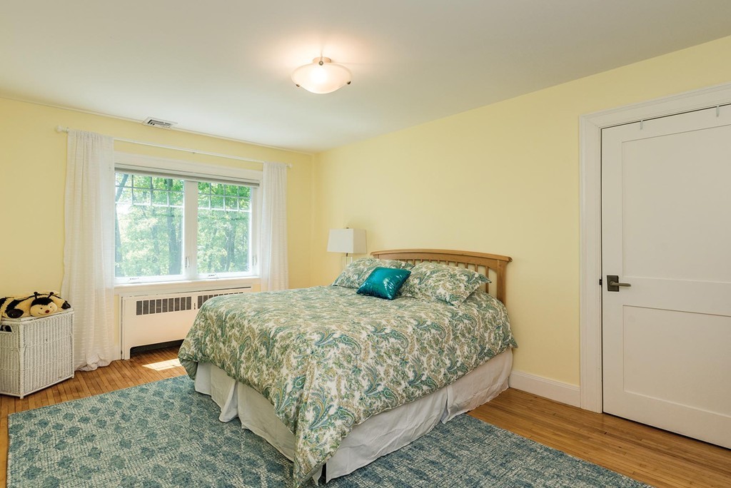 87 Beverly Road Brookline, MA 02467 - Photo 11 of 16 a bedroom with a bed and wooden floor