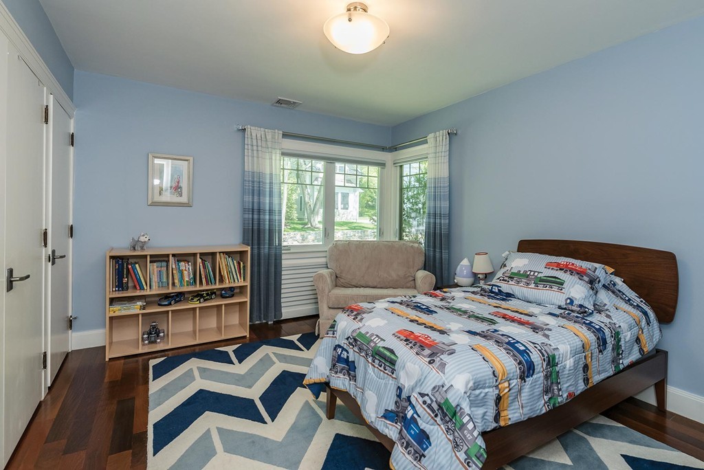 87 Beverly Road Brookline, MA 02467 - Photo 12 of 16 a bedroom with a bed and a book shelf