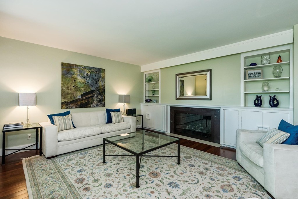 87 Beverly Road Brookline, MA 02467 - Photo 3 of 16 a living room with furniture and a fireplace
