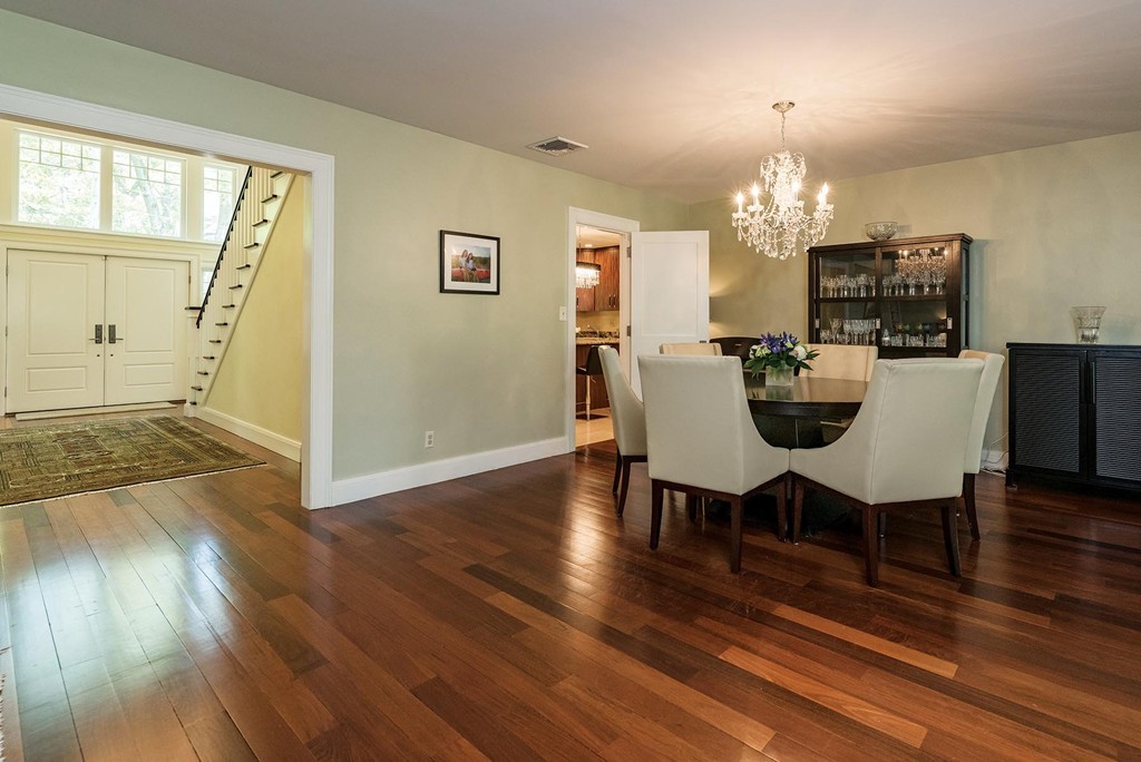 87 Beverly Road Brookline, MA 02467 - Photo 4 of 16 a view of a dining room with furniture a chandelier and wooden floor