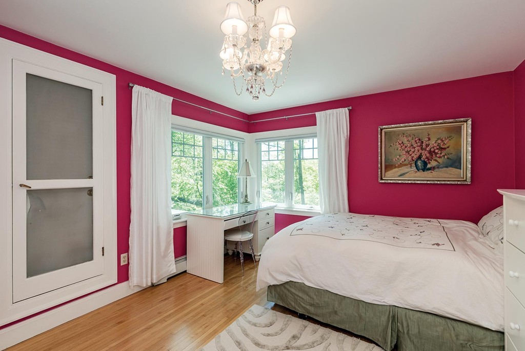 87 Beverly Road Brookline, MA 02467 - Photo 10 of 16 a bedroom with a bed and a chandelier
