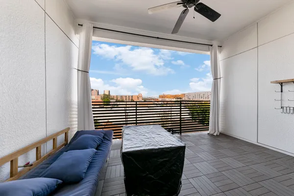 a view of a livingroom with workspace and a window