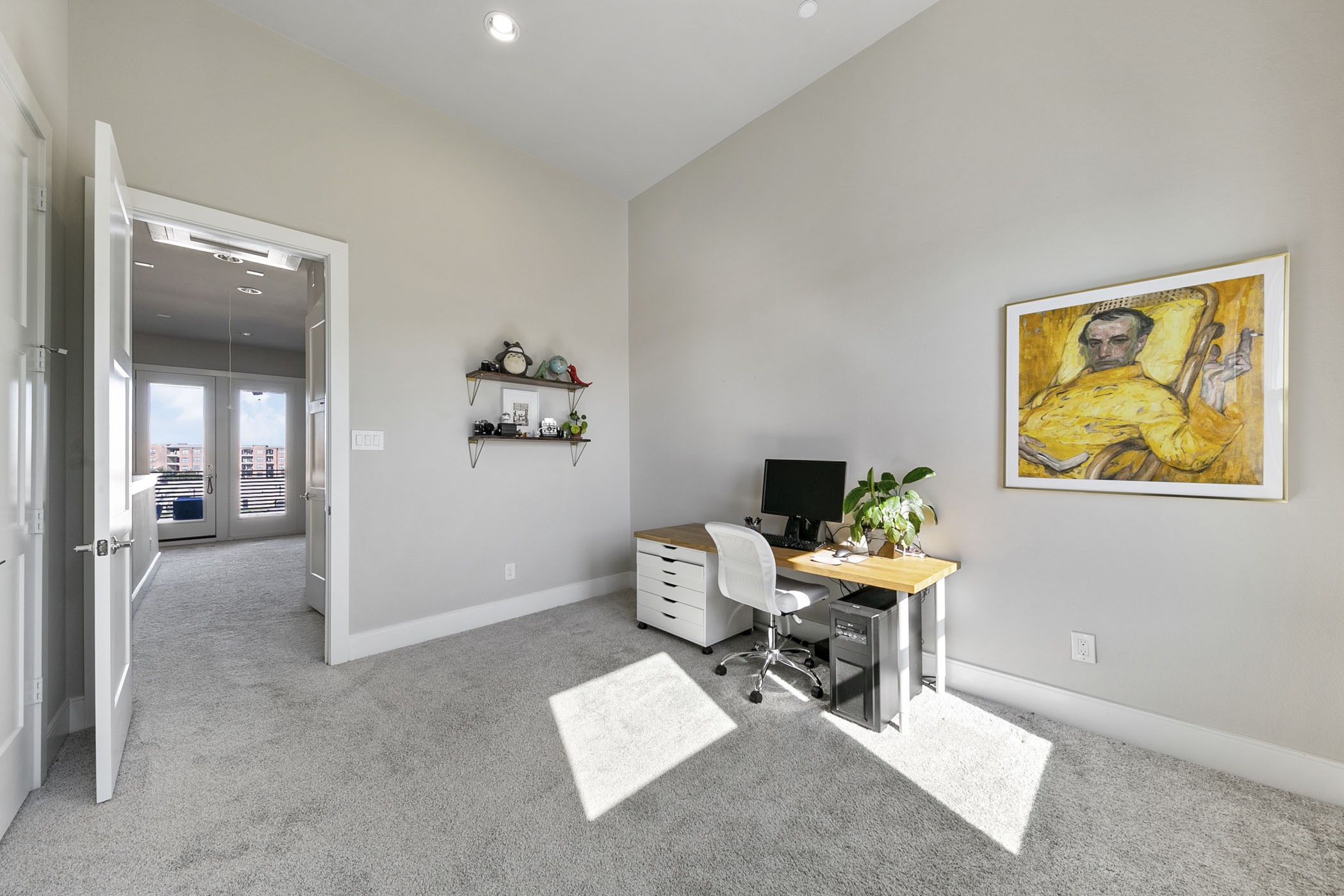 2412 Canal Street, Unit J Houston, TX 77003 - Photo 16 of 19 a workspace with furniture and painting on the wall