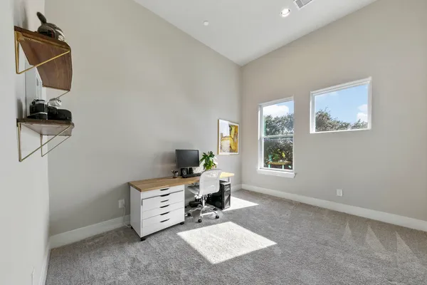a workspace with furniture and painting on the wall