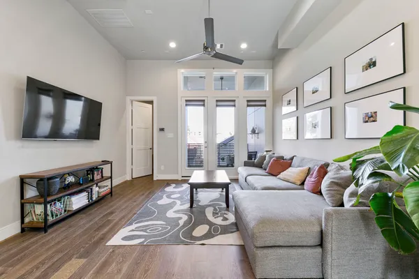 a living room with furniture and wooden floor