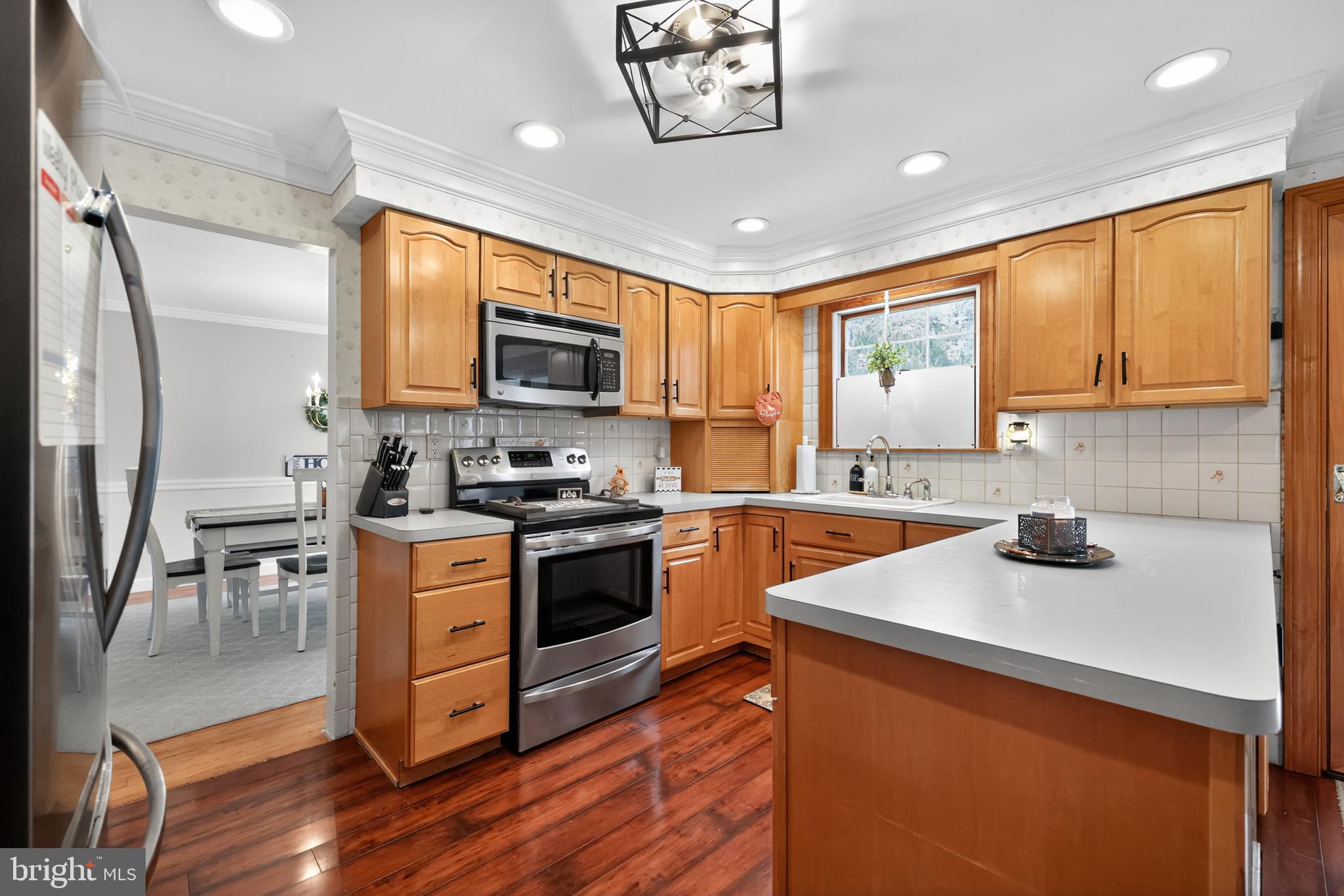665 Chatham Road Somerdale, NJ 08083 - Photo 12 of 36 a kitchen with stainless steel appliances a stove a sink a refrigerator cabinets and a counter top space