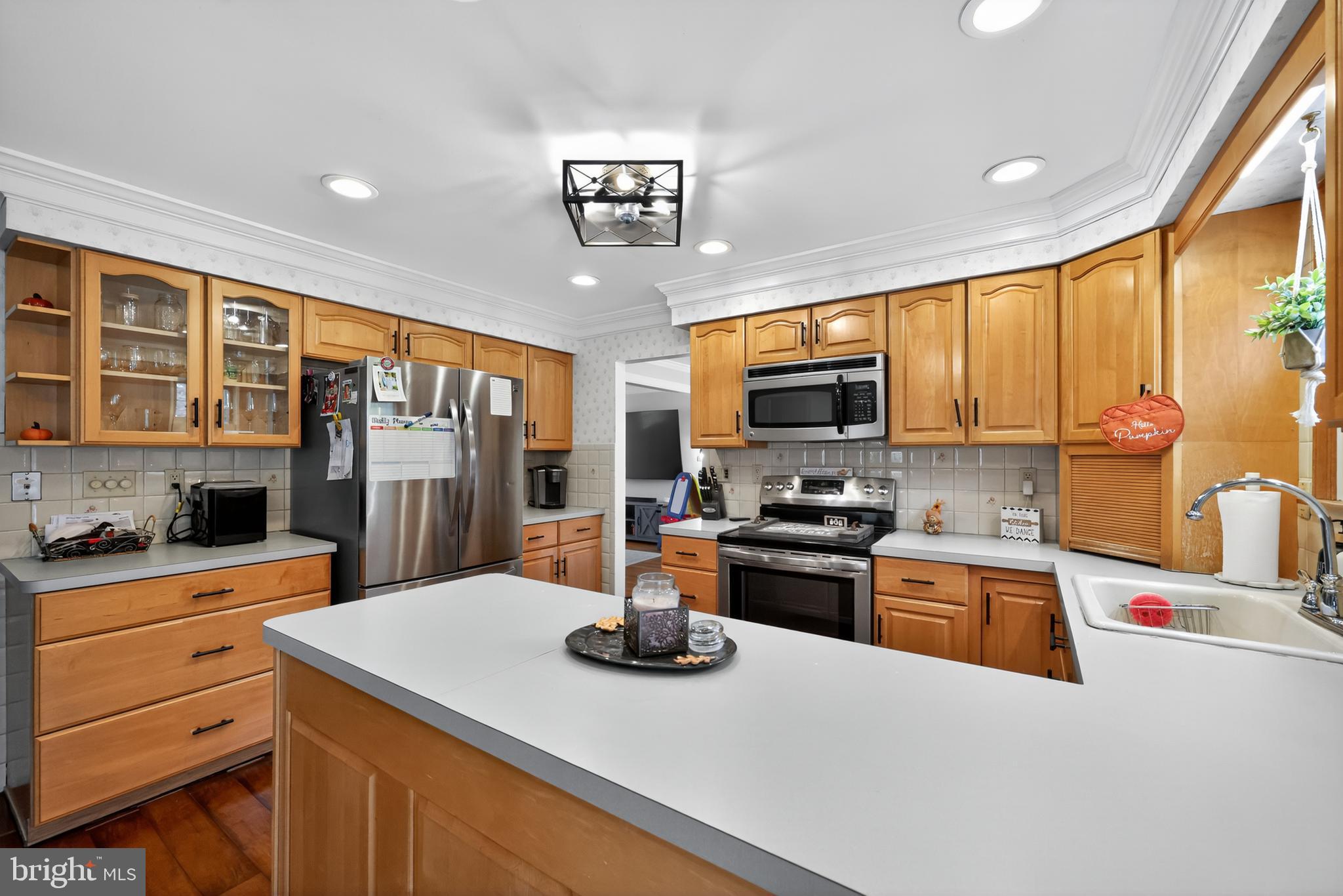 665 Chatham Road Somerdale, NJ 08083 - Photo 14 of 36 a kitchen with a sink a counter top space and stainless steel appliances