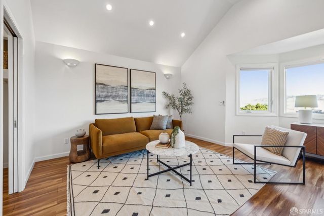 a kitchen with granite countertop wooden cabinets stainless steel appliances and a center island