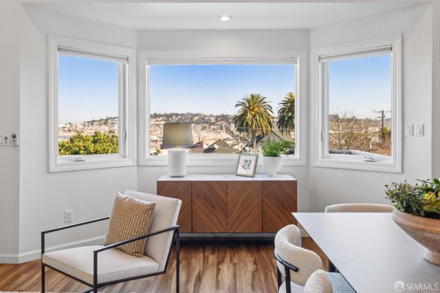 a bedroom with a large bed and a wooden floor