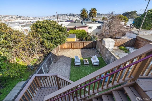 a spacious bathroom with a granite countertop sink a toilet and a large mirror