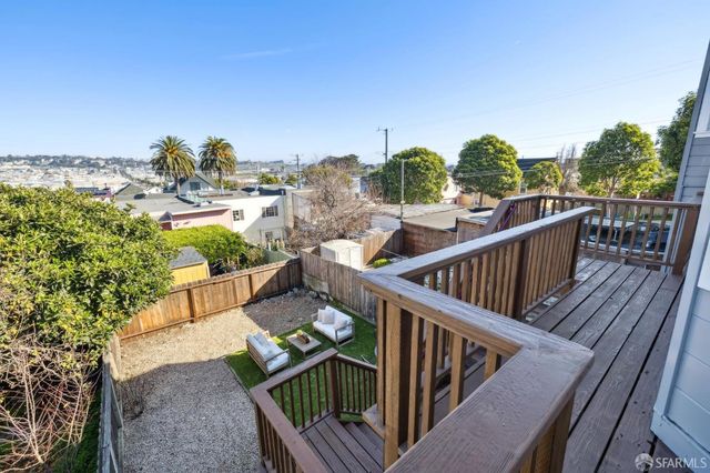 a view of a porch with a table and chairs