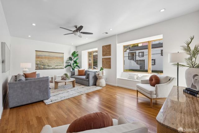 a living room with furniture and a lamp