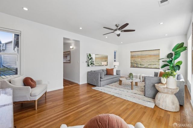 a living room with furniture and a potted plant