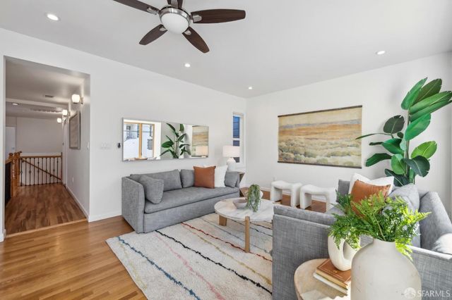 a living room with furniture and a large mirror