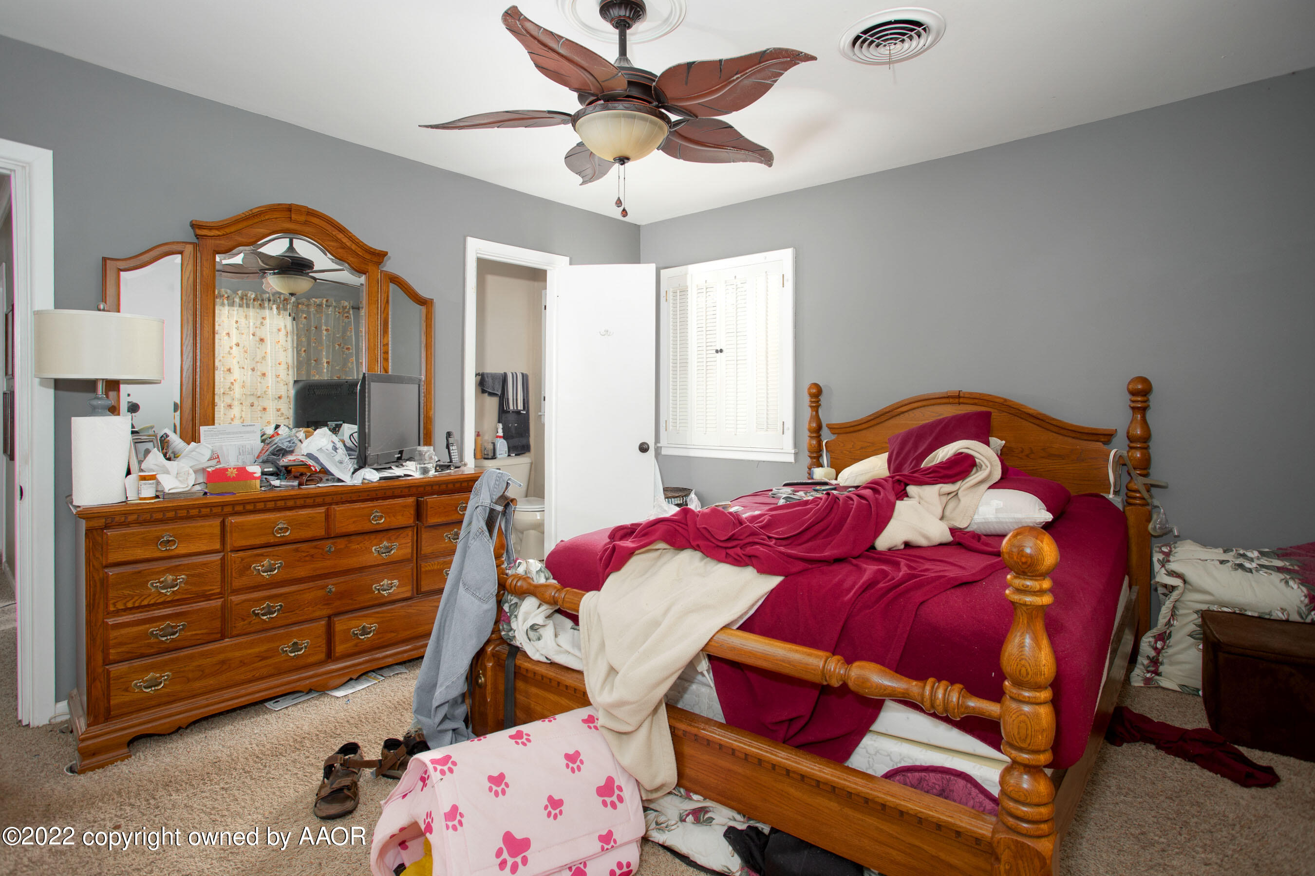 3607 Patterson Drive Amarillo, TX 79109 - Photo 17 of 24 a bedroom with a bed and a chandelier