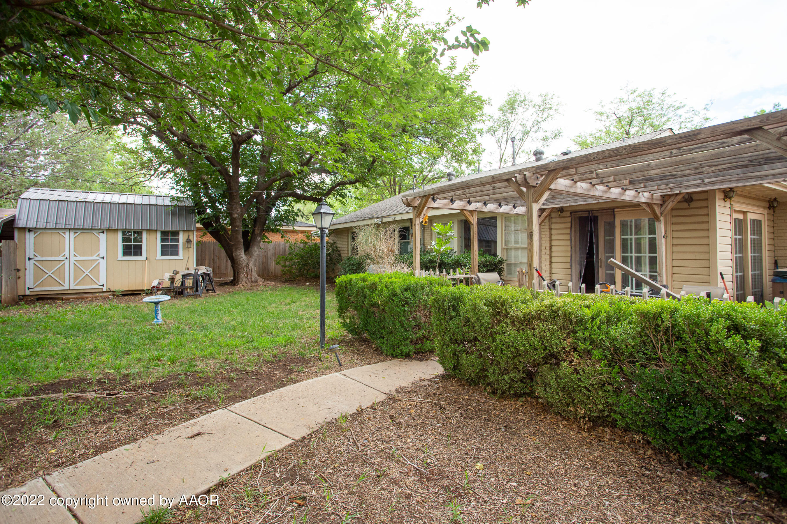 3607 Patterson Drive Amarillo, TX 79109 - Photo 22 of 24 a front view of a house with a yard and plants