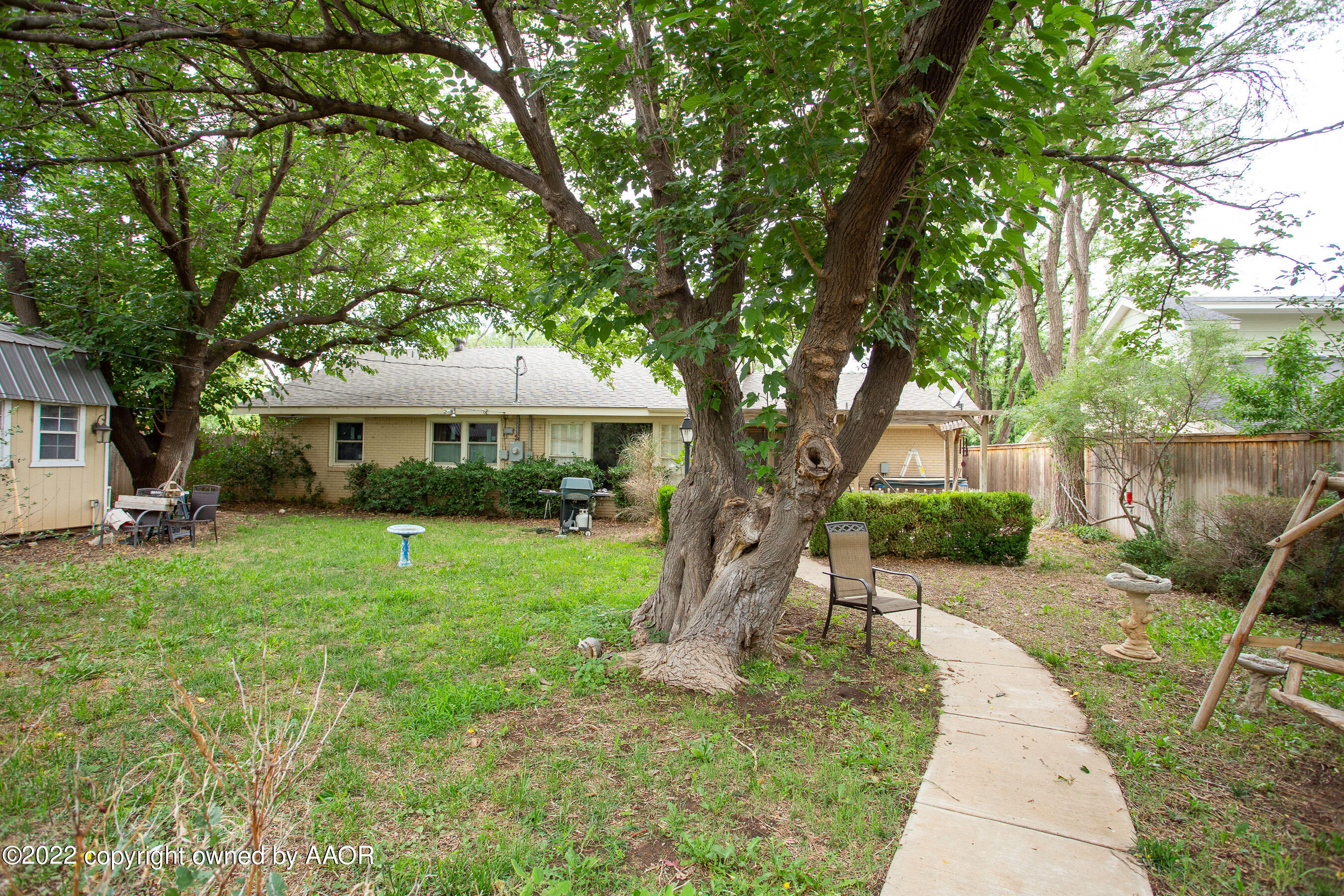 3607 Patterson Drive Amarillo, TX 79109 - Photo 23 of 24 a front view of a house with a yard and trees