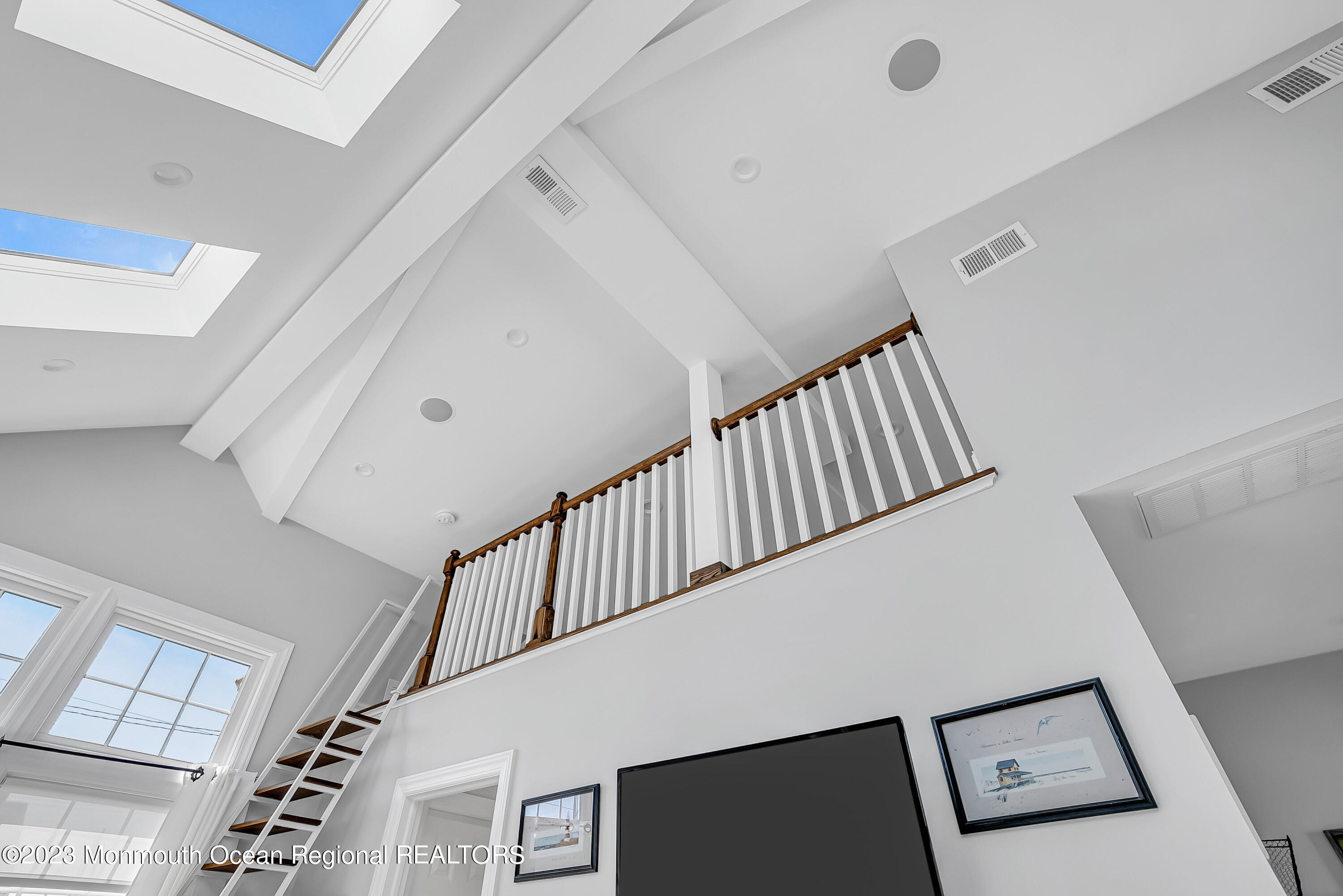 26 East Shell Way Lavallette, NJ 08735 - Photo 13 of 46 a view of staircase with lots of frames on wall and a window