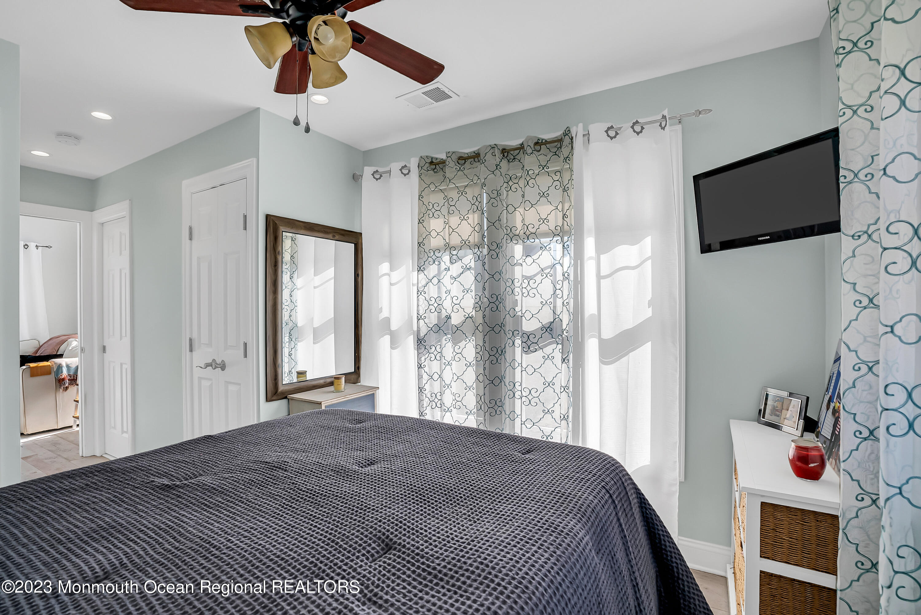 26 East Shell Way Lavallette, NJ 08735 - Photo 18 of 46 a bedroom with a bed and a flat screen tv