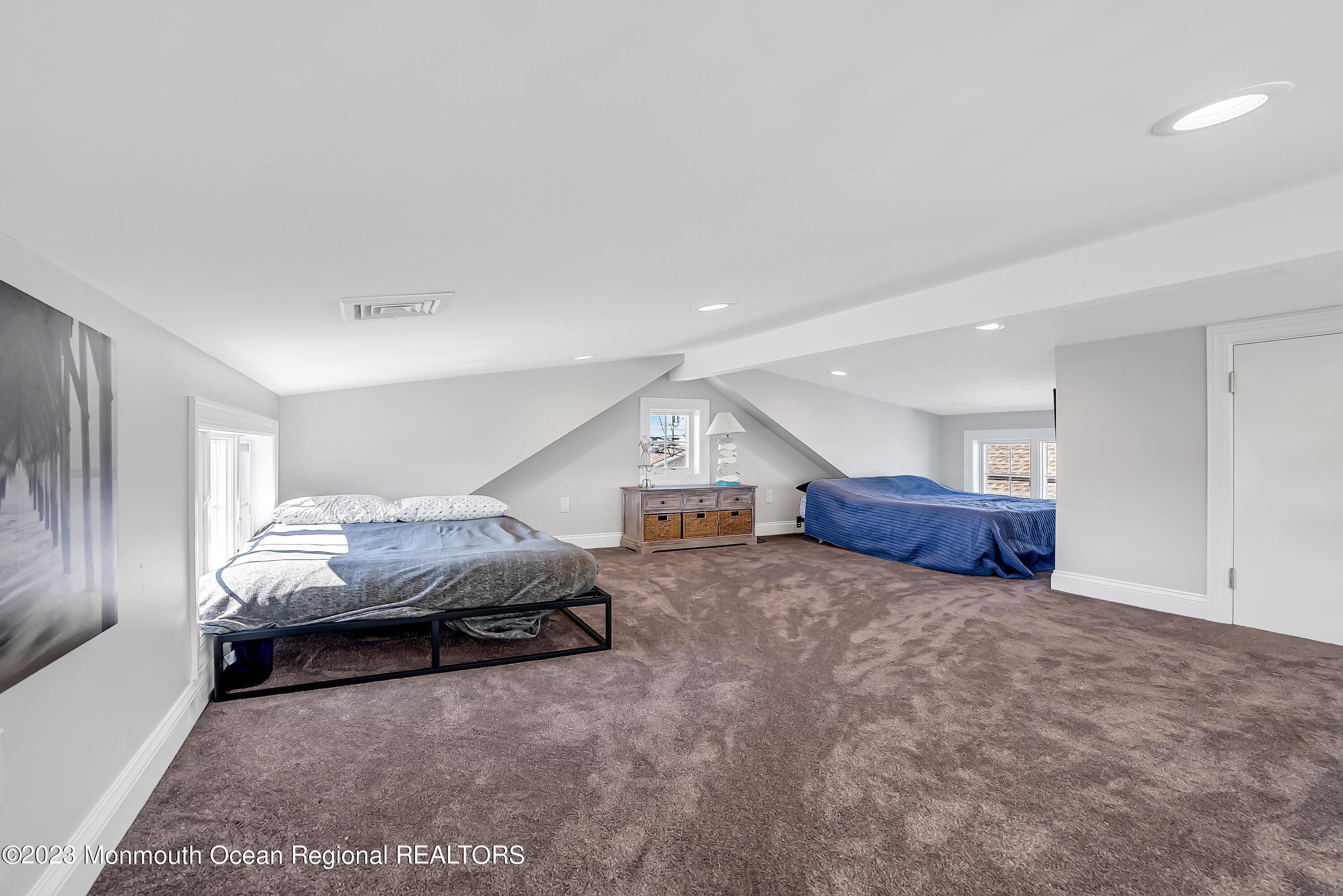 26 East Shell Way Lavallette, NJ 08735 - Photo 20 of 46 a spacious bedroom with a bed and a large window