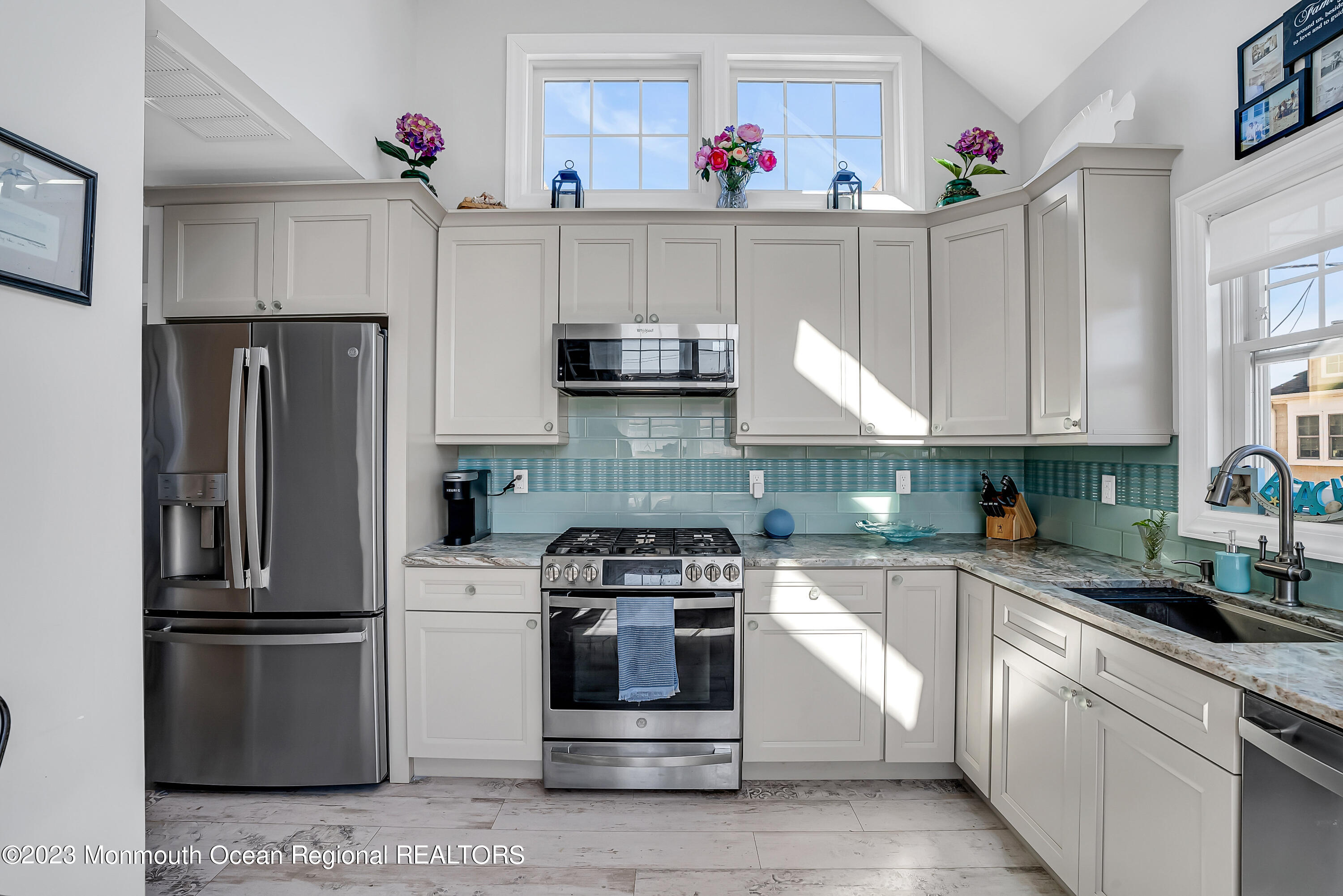 26 East Shell Way Lavallette, NJ 08735 - Photo 6 of 46 a kitchen with granite countertop white cabinets and stainless steel appliances
