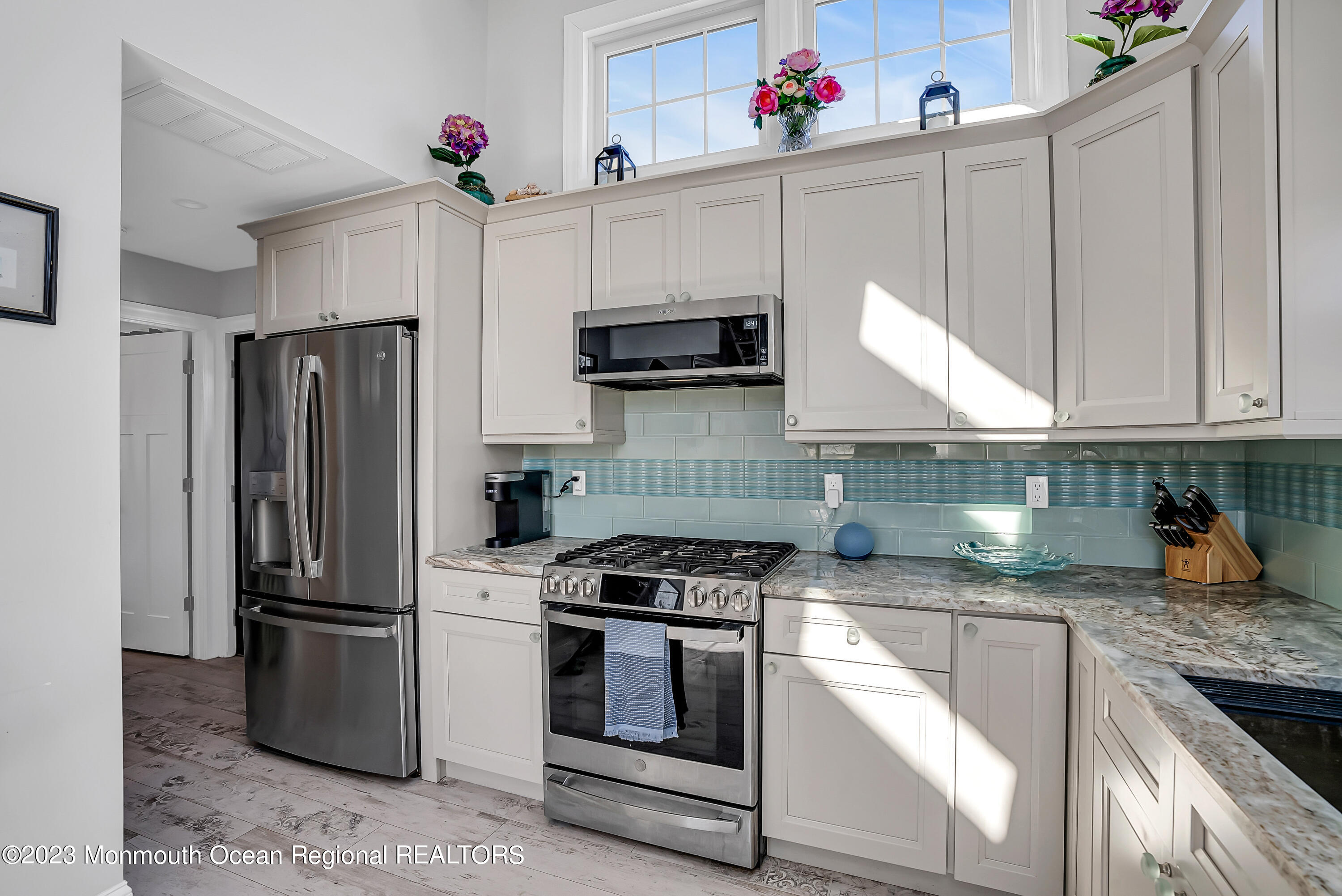 26 East Shell Way Lavallette, NJ 08735 - Photo 7 of 46 a kitchen with granite countertop a refrigerator stove and microwave
