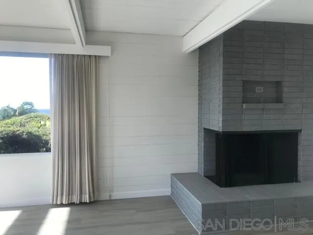 5616 Abalone Place La Jolla, CA 92037 - Photo 10 of 18 a living room with a fireplace