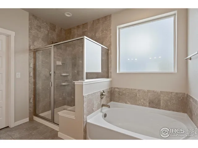 a bathroom with a tub a sink and a shower