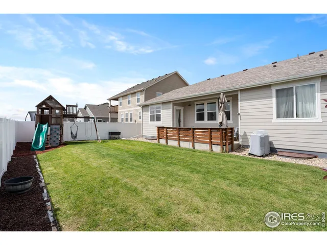 a view of a house with backyard and porch
