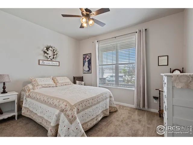 a bedroom with a bed a dresser and a window
